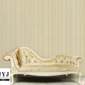 Luxurious,golden,sofa,on,a,background,of,old,white,wall